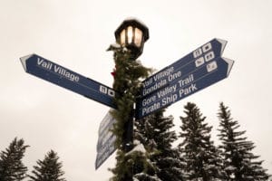 A look at a traditional streetlight with arrows pointing to various attractions in Vail, Colorado.