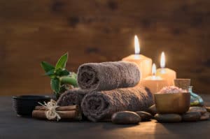 Photo of candles and towels at a spa for the perfect wellness retreat in Colorado.