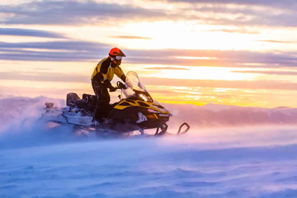Photo of a person embarking on a Vail snowmobile tour