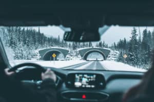 Photo of a car on a snowy road traveling from Denver to Vail