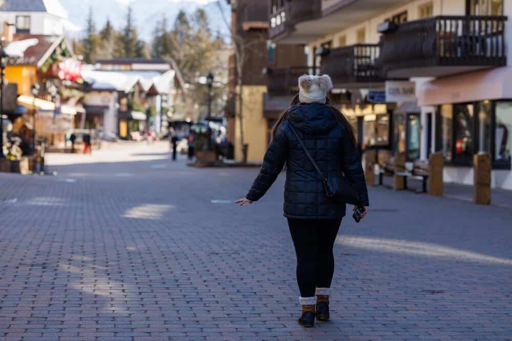 Woman walking down the street shopping in Vail Village